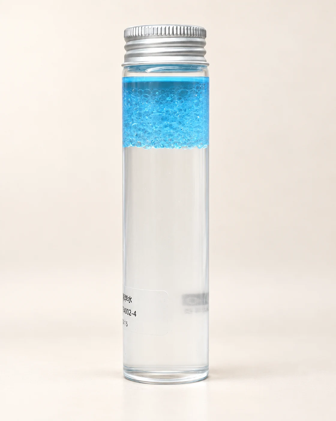 Blue beads in a clear sample bottle, from supplied footage; AI-retouched still